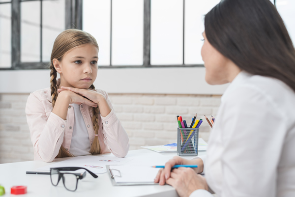 Child being counseled by therapist